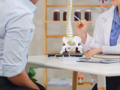 Spinal cord injury doctor reviewing imaging with patient