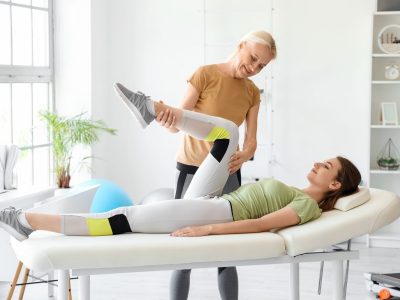 Sports chiropractor adjusting athlete's spine during treatment