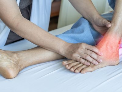 Doctor examining patient's ankle for tarsal tunnel syndrome