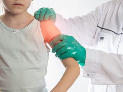 Doctor assessing shoulder with highlighted pain area indicating shoulder labrum injury location