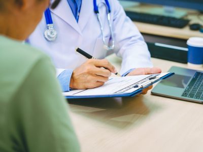 Healthcare provider explaining migraine treatment options to patient
