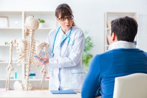 Healthcare provider evaluating rib pain during rib injury treatment consultation