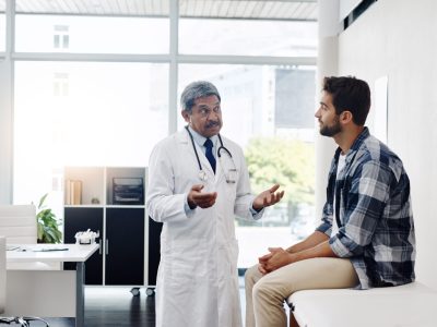 Medical provider consulting male patient about testosterone therapy