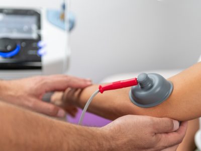 Sports medicine specialist examining pitcher's elbow for UCL injury