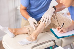 Healthcare provider examining patient during varicose veins treatment consultation