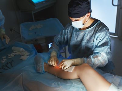 Vascular surgeon examining patient during consultation